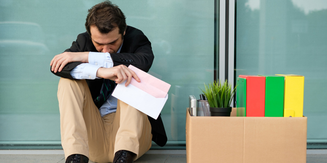 Fired businessman reading the notice of job termination